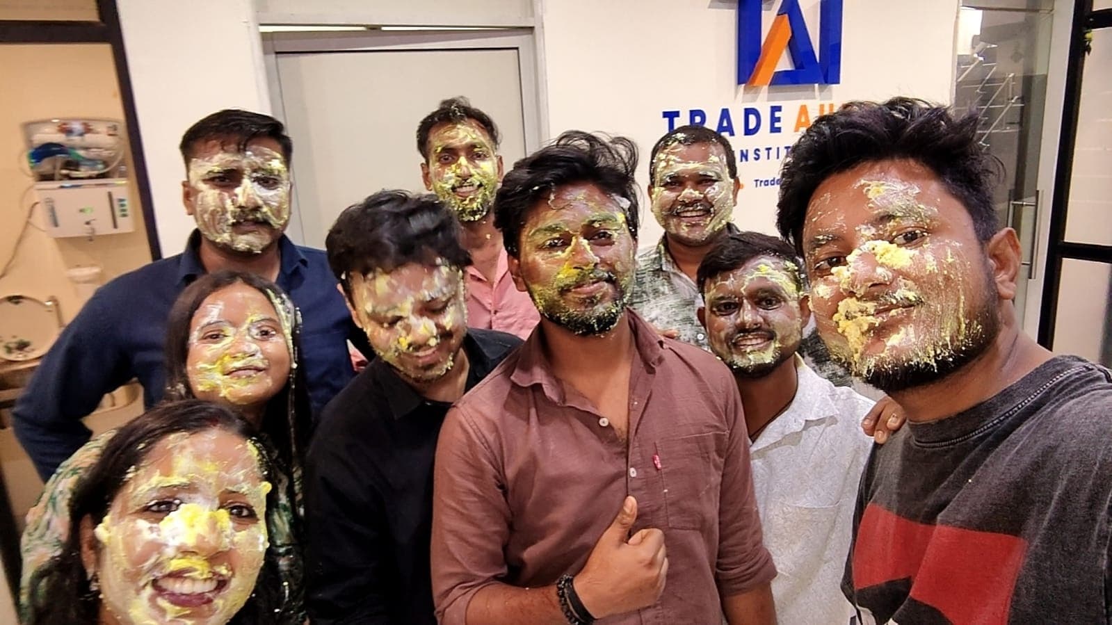 Students and staff sharing a joyful birthday moment at TradeAura Institute