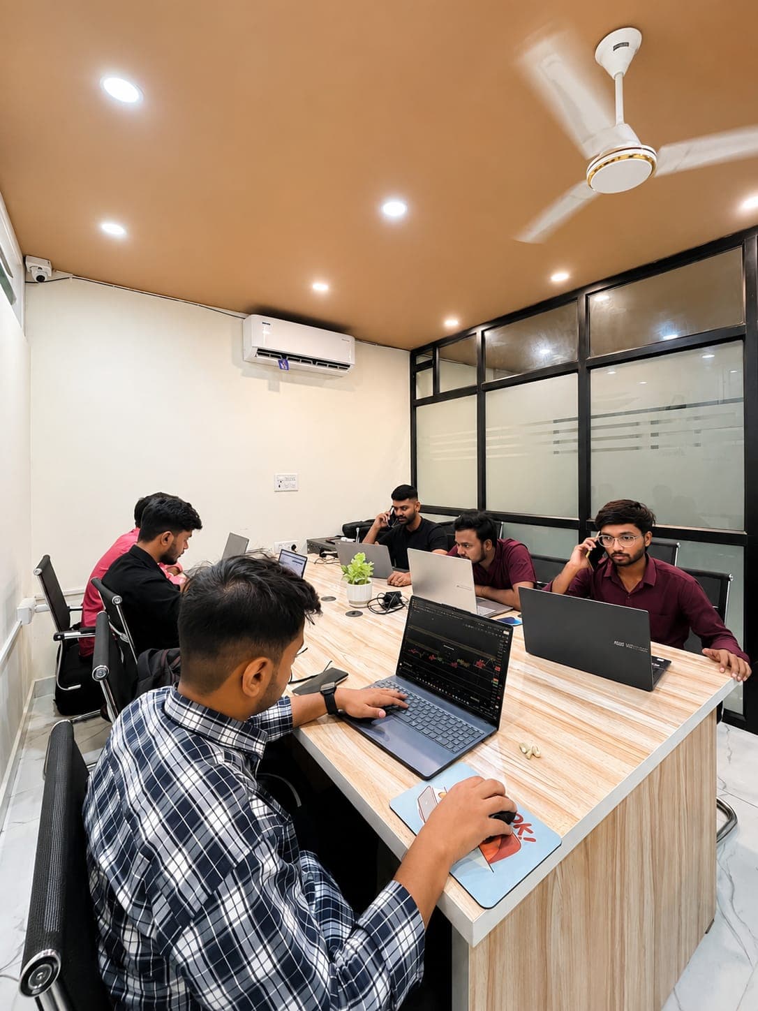 A full trading classroom of students practising on laptops during a session at TradeAura Institute