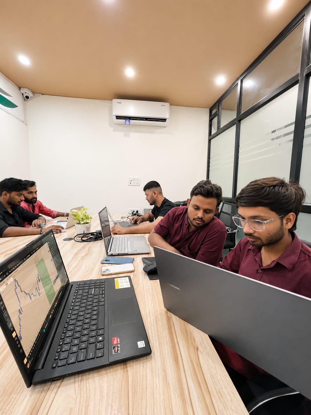 Students focused on analysing candlestick charts on their laptops at TradeAura Institute